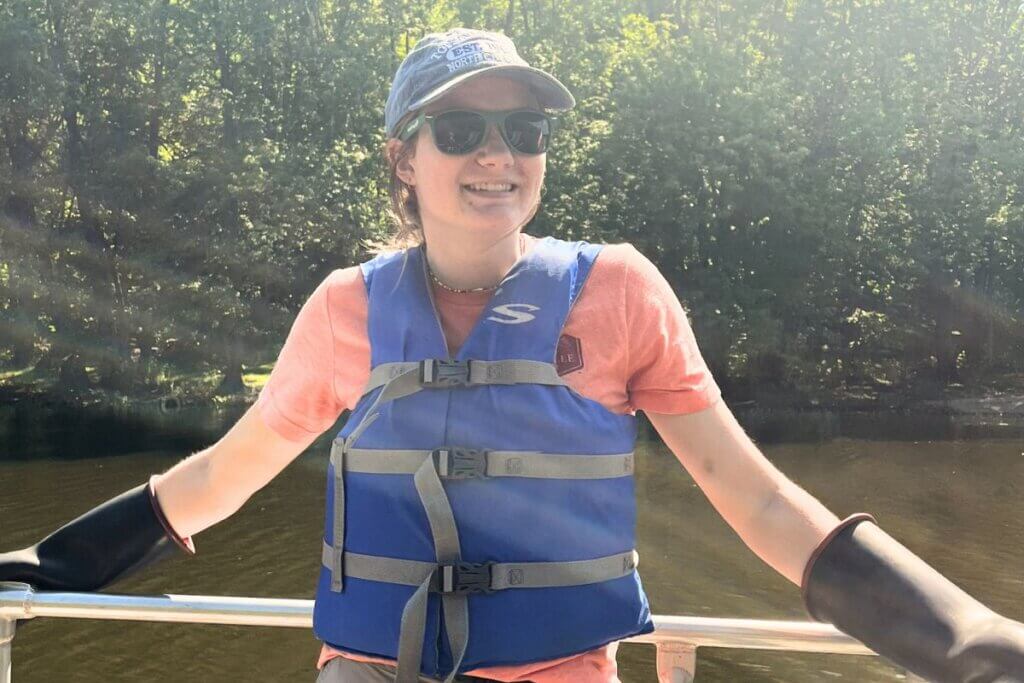 Photo of Kaitlin Koster '24 on a boat and smiling