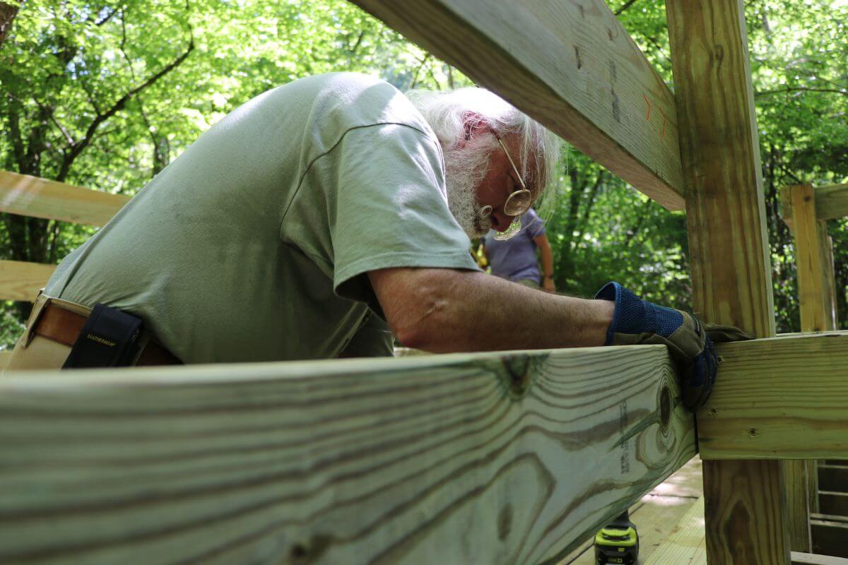 Photo of a man working on a bridge