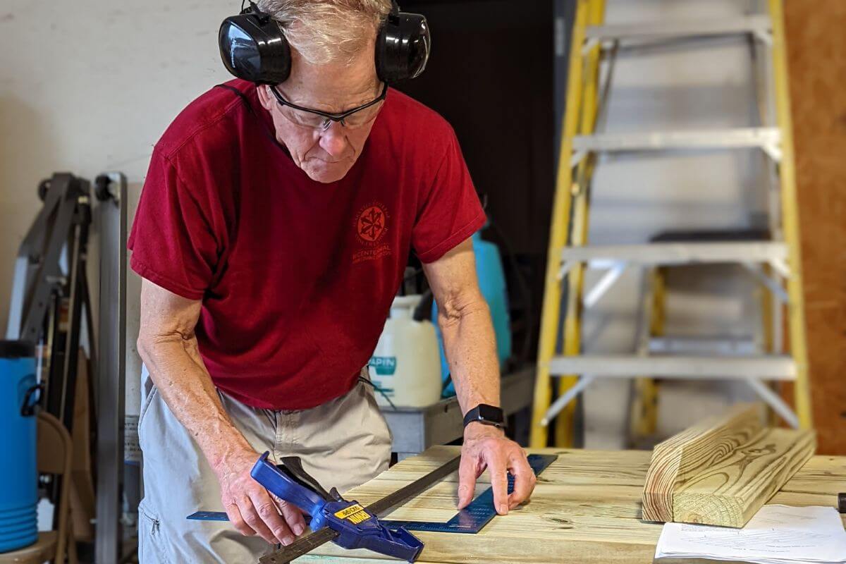 Photo of Dr. Marvin Beard measuring a board at KT Days 2022