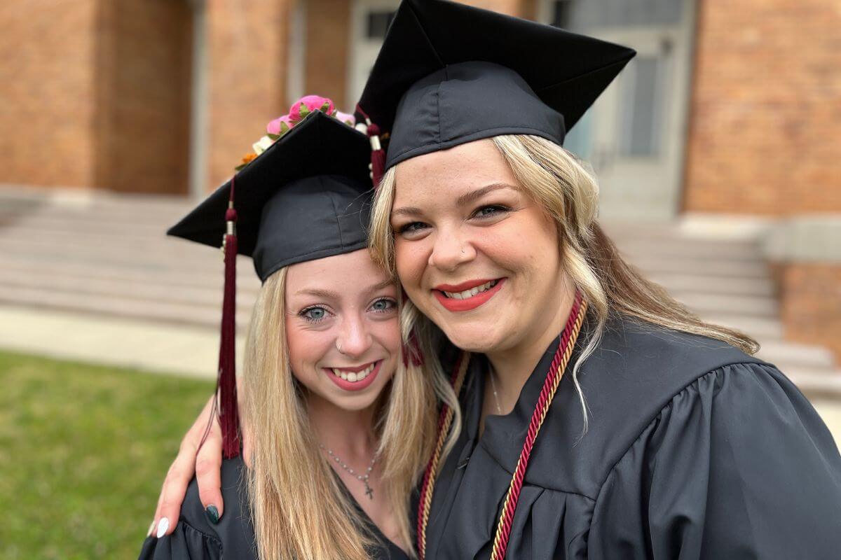 Photo of Khalie Cleveland hugging Emilee Grace Fowler in front of the Clayton Center for the Arts on May 6, 2023.