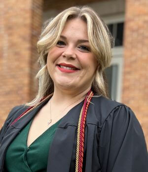 Photo of Khalie Cleveland in her graduation gown and cords