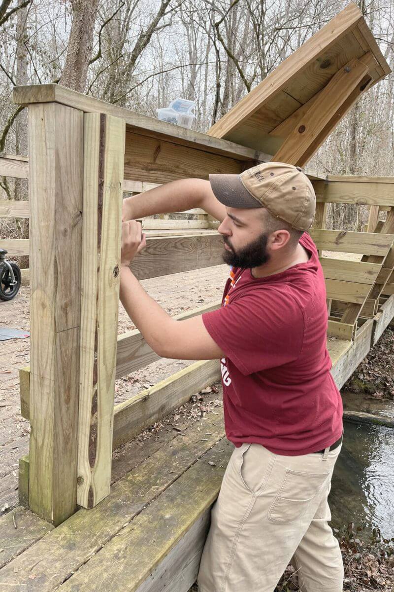 Photo of Trevor Gaines-Perry installing a tracker in the MC Woods