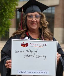 Photo of Angela Stolpe in cap and gown at MC Commencement 2023