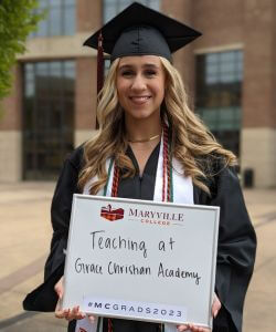 Photo of Anna Kate Bechman in cap and gown at Commencement 2023