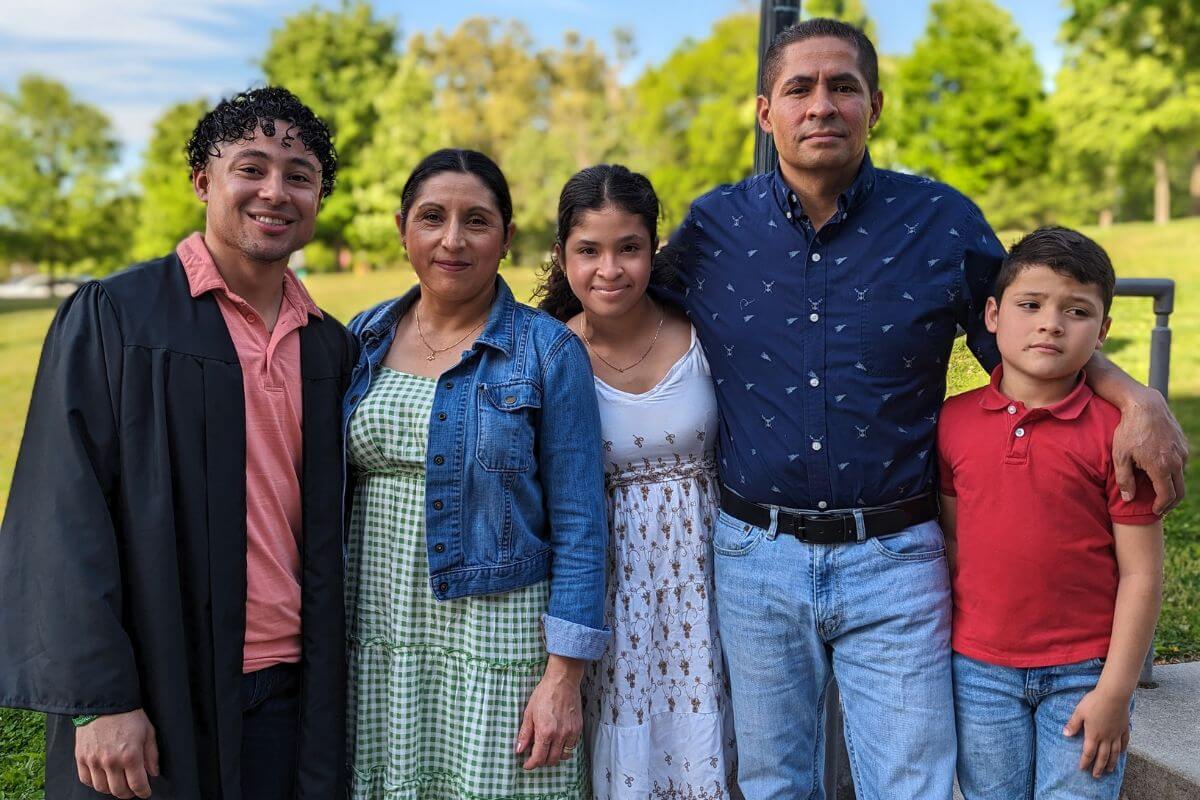 Photo of a Maryville College senior with his family on the steps of the Clayton Center for the Arts
