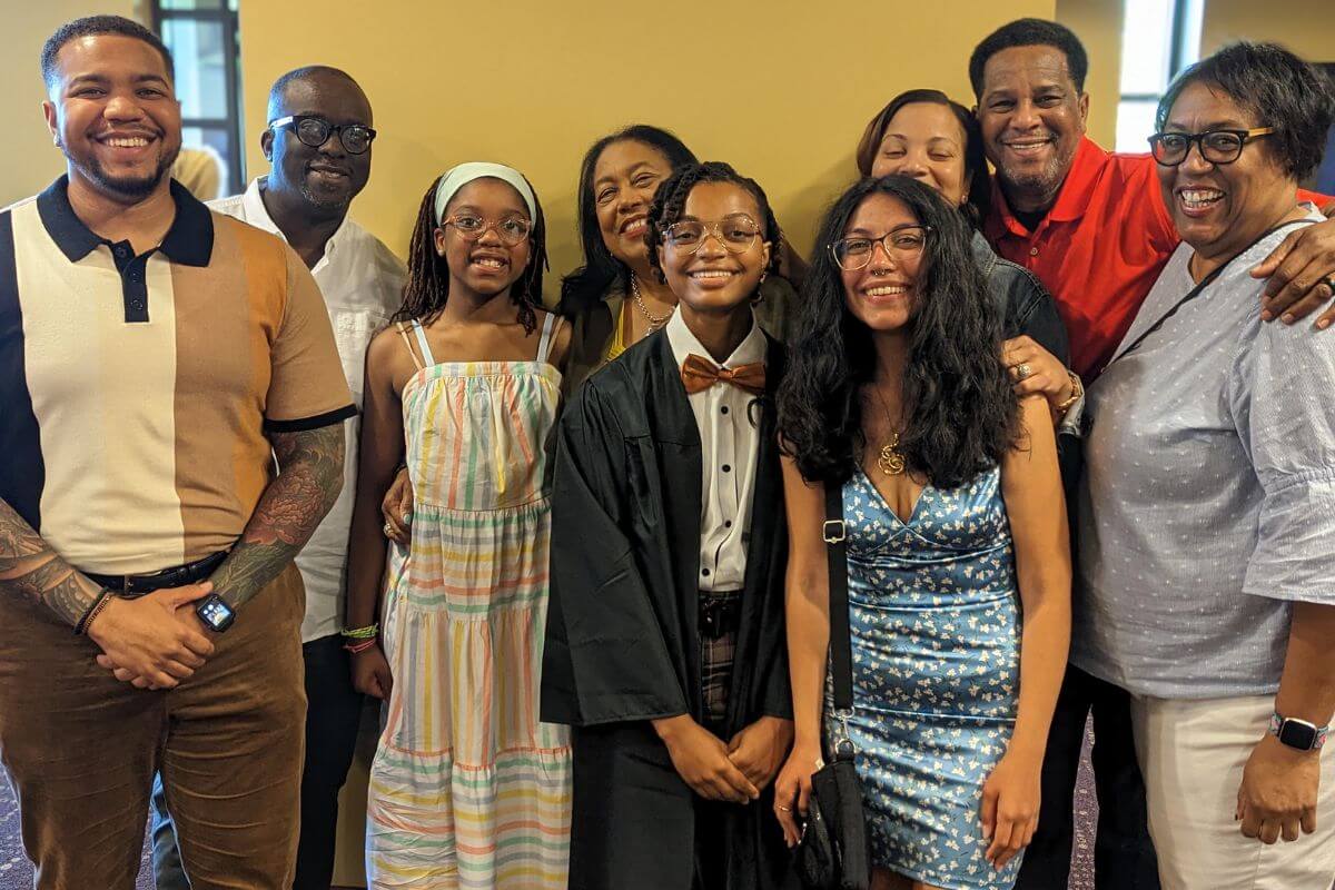 Photo of smiling family inside the Clayton Center after the 2023 Baccalaureate.