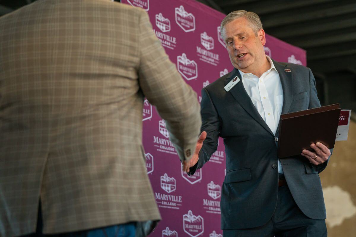 Photo of Dr. Bryan Coker shaking hands with someone