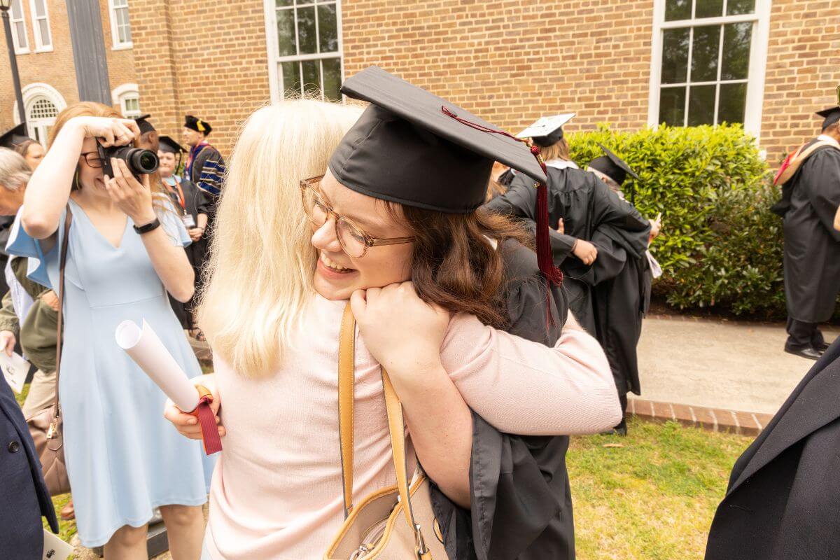 Photo of a 2023 Maryville College graduate hugging a loved one