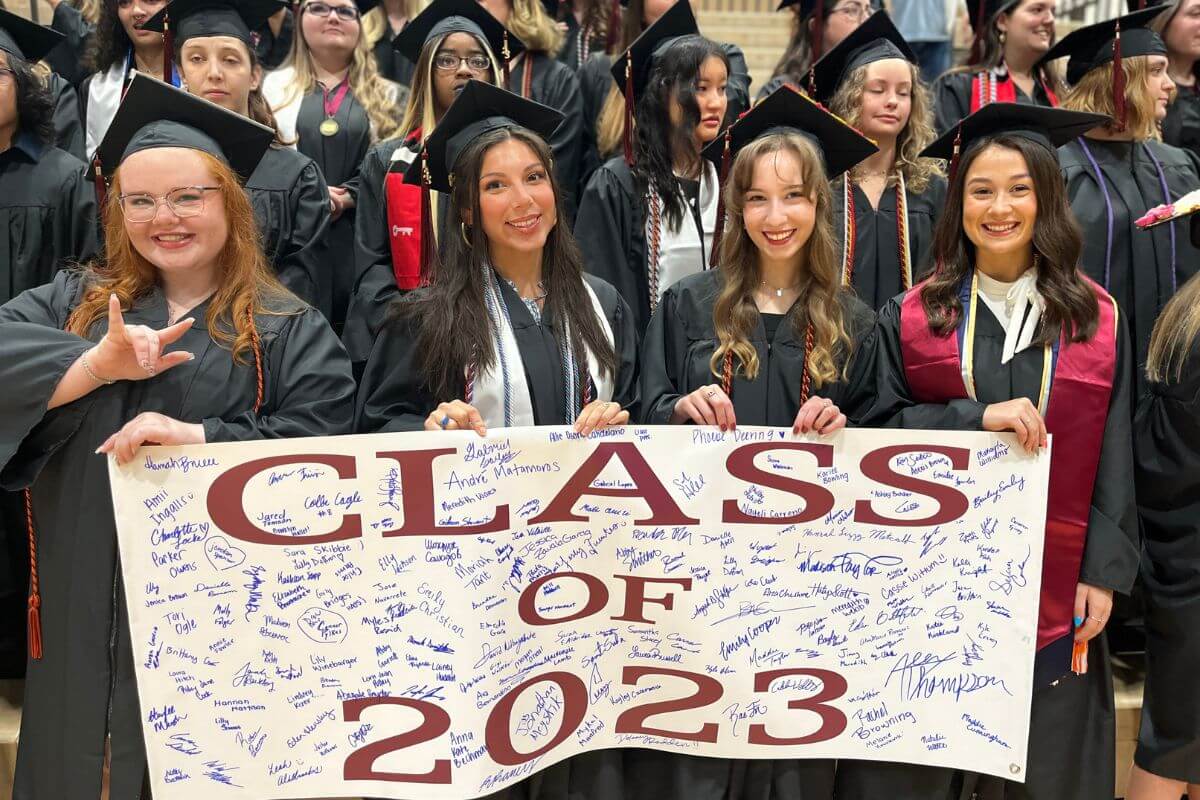 Photo of seniors holding the Class of 2023 banner in the Cooper Athletic Center