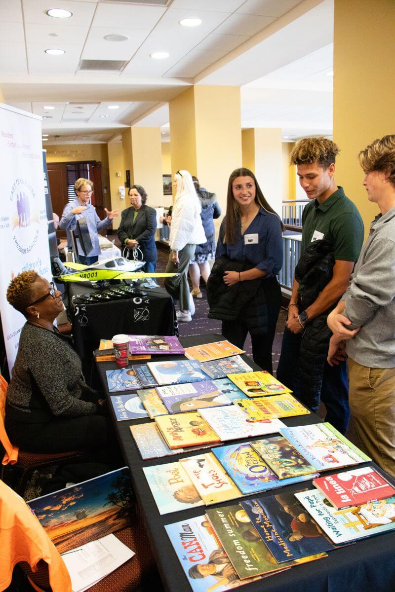 Photo of two students talking to representative of East Tennessee Freedom Schools