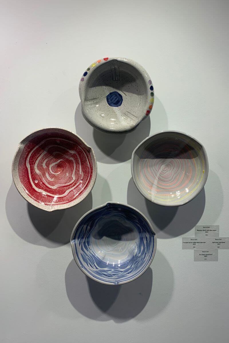 A photo of four bowls hanging on the wall