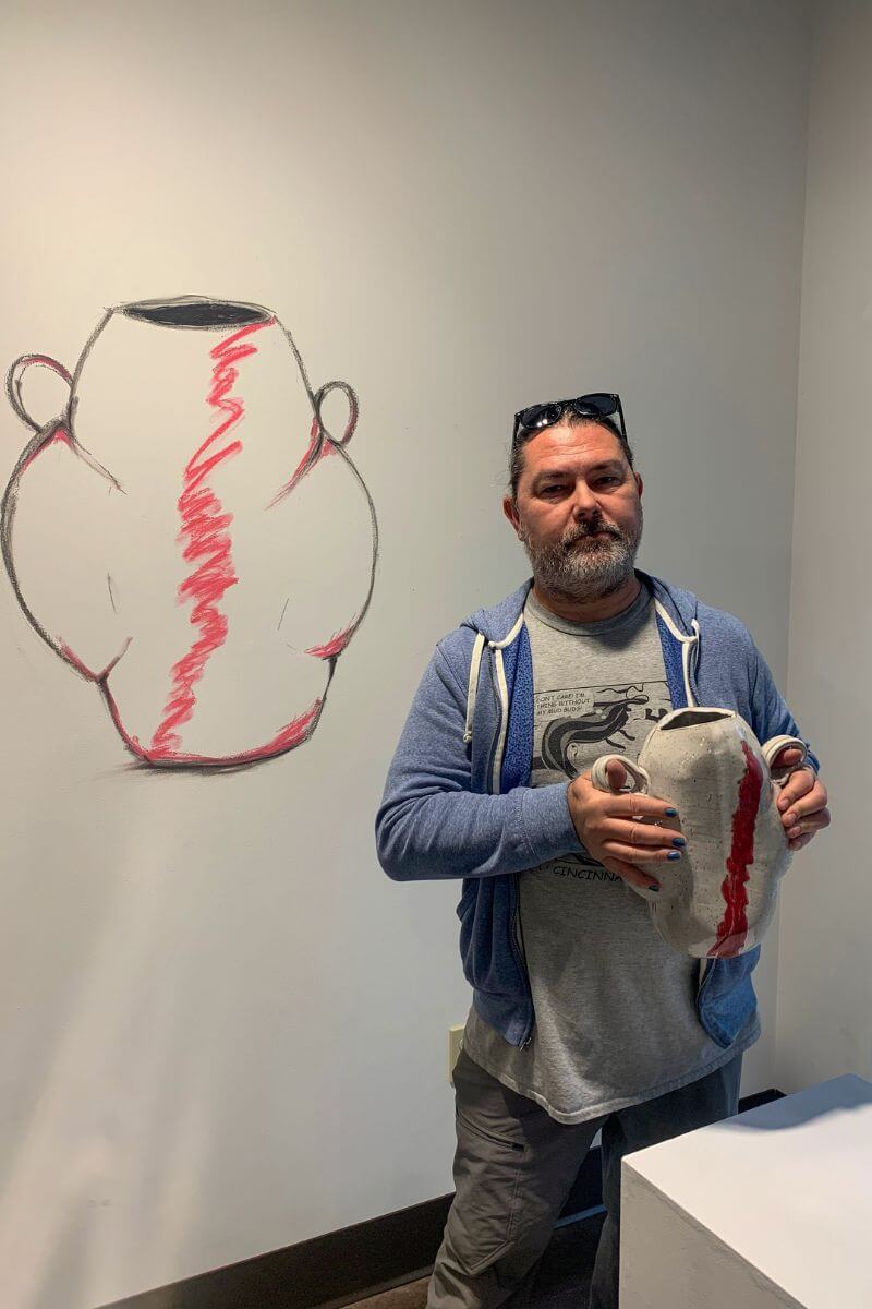 Photo of Barron Hall holding a vase