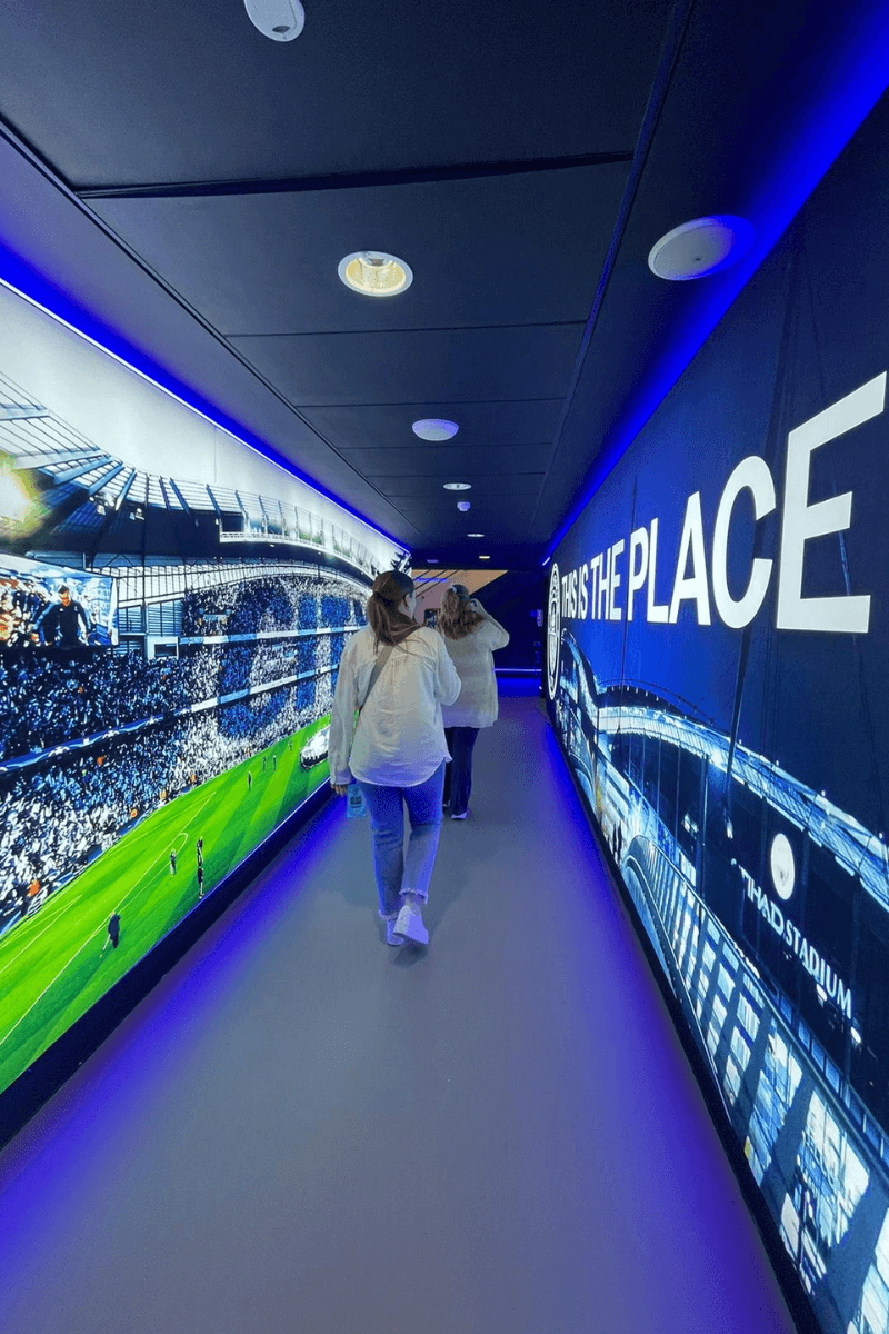 Three students walk down a hallway