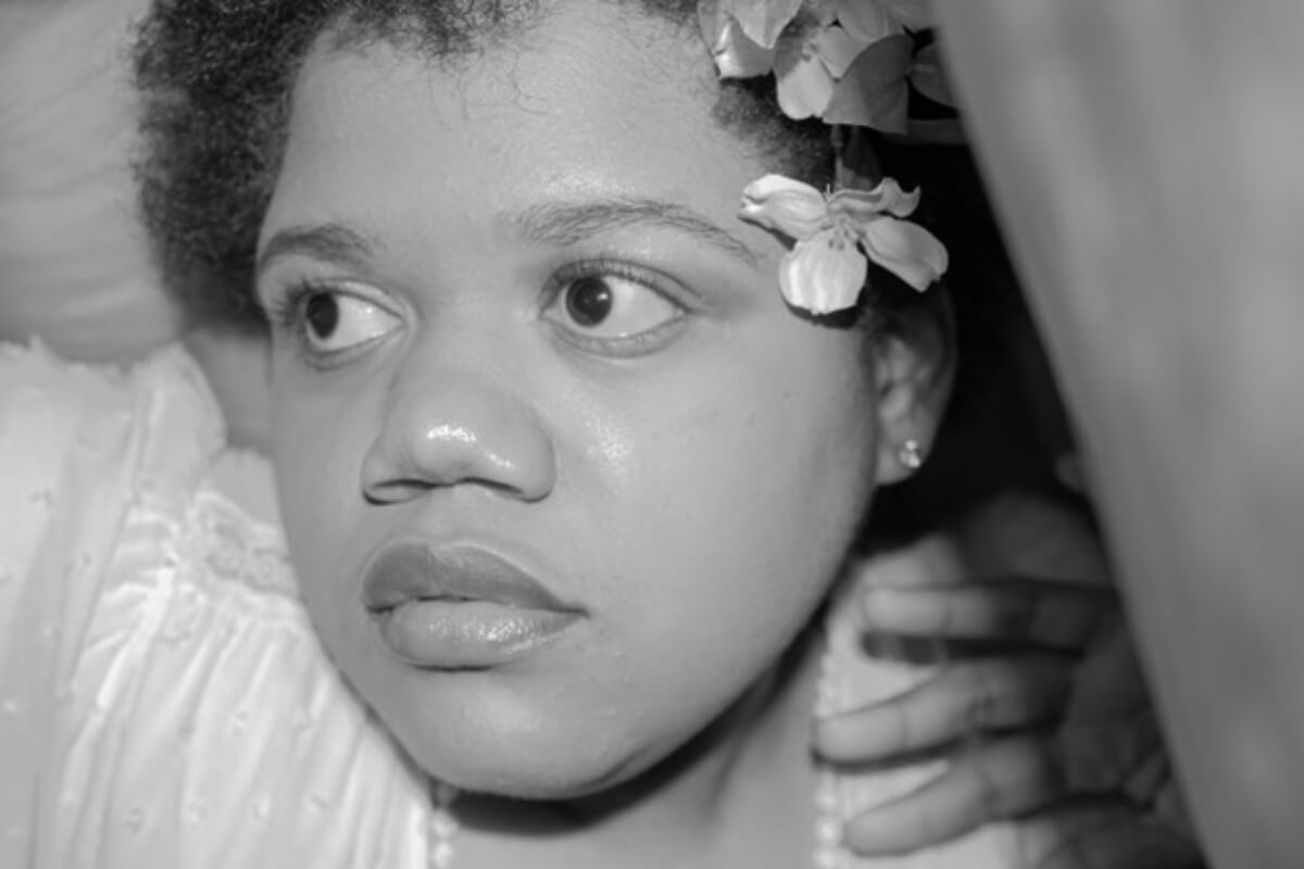Black-and-white photo of a young African American girl by Rian Dixon