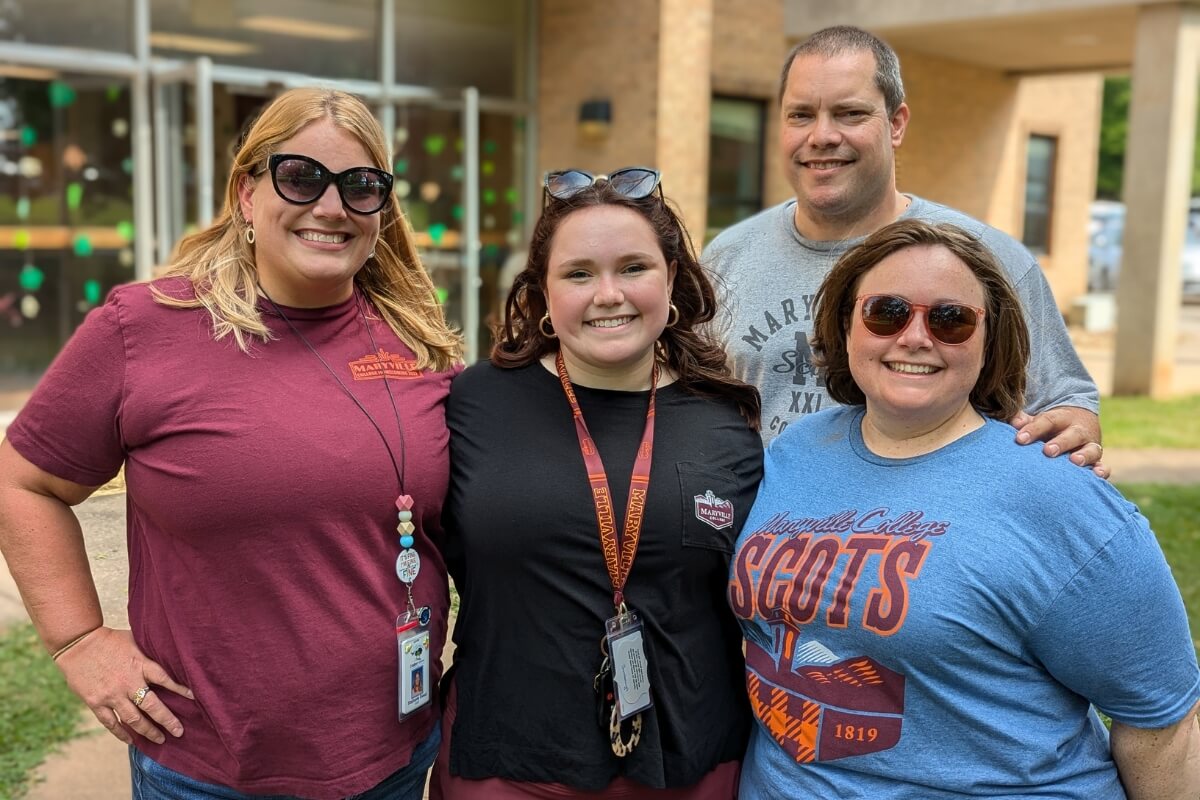 Photo of Olivia Bumbalough with Aunt Stephanie Bumbalough Sweet '05, dad Scott Bumbalough '03 and mom Jessica Foster Bumbalough '03