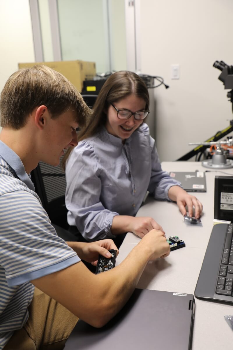Photo of two Maryville College interns working at ORNL during the summer of 2024.