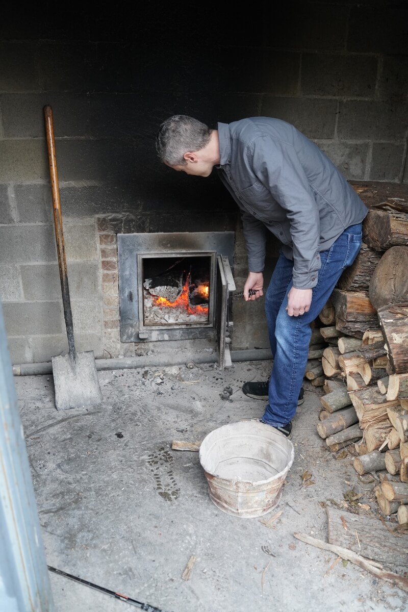 Photo of Maryville College's Darrell Benton stoking a smoker
