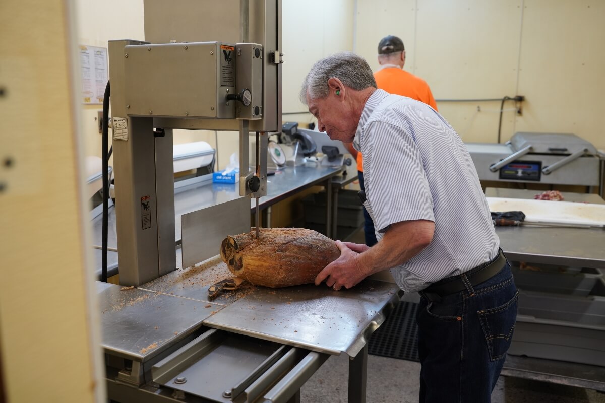 Photo of Allan Benton cutting country ham