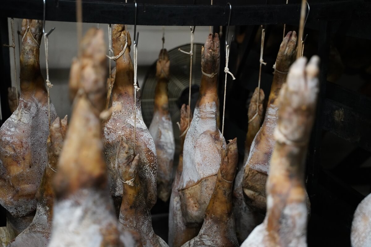 Photo of racks of pork hanging to dry