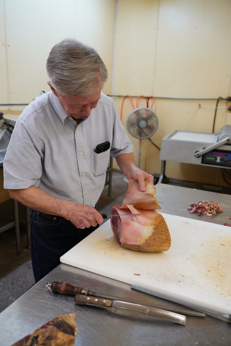 Photo of Allan Benton carving meat