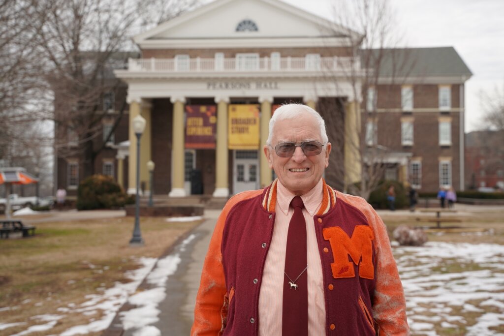 Photo of Dr. Hugh McCampbell '66 standing in front of Pearsons Hall on the Maryville College campus