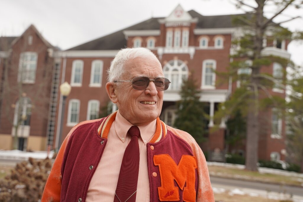 Photo of Dr. Hugh McCampbell '66 standing in front of Bartlett Hall