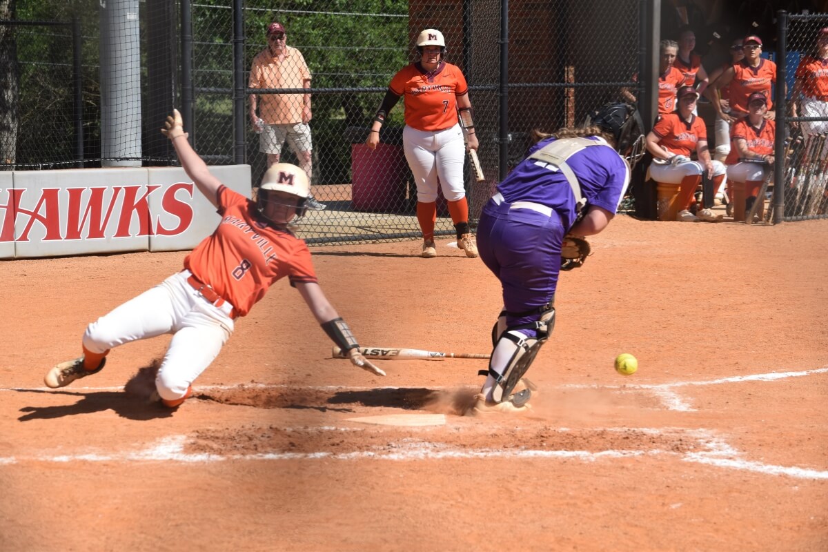 Photo of MC softball player sliding into home