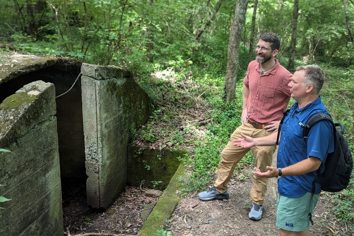 Photo of Ben Taylor and Dr. Drew Crain inspecting a newly discovered structure in the Maryville College Woods