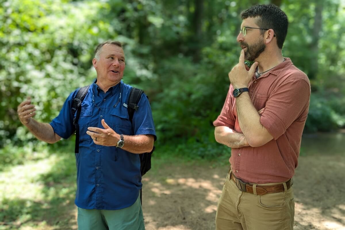 Photo of Dr. Drew Crain explaining something to Dr. Ben Taylor '06.