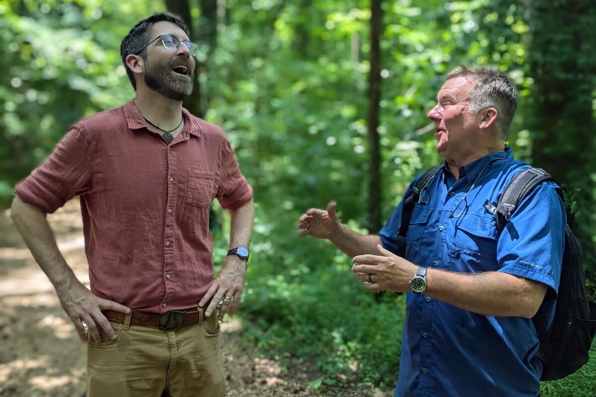 Photo of a laughing Ben Taylor talking with Dr. Drew Crain