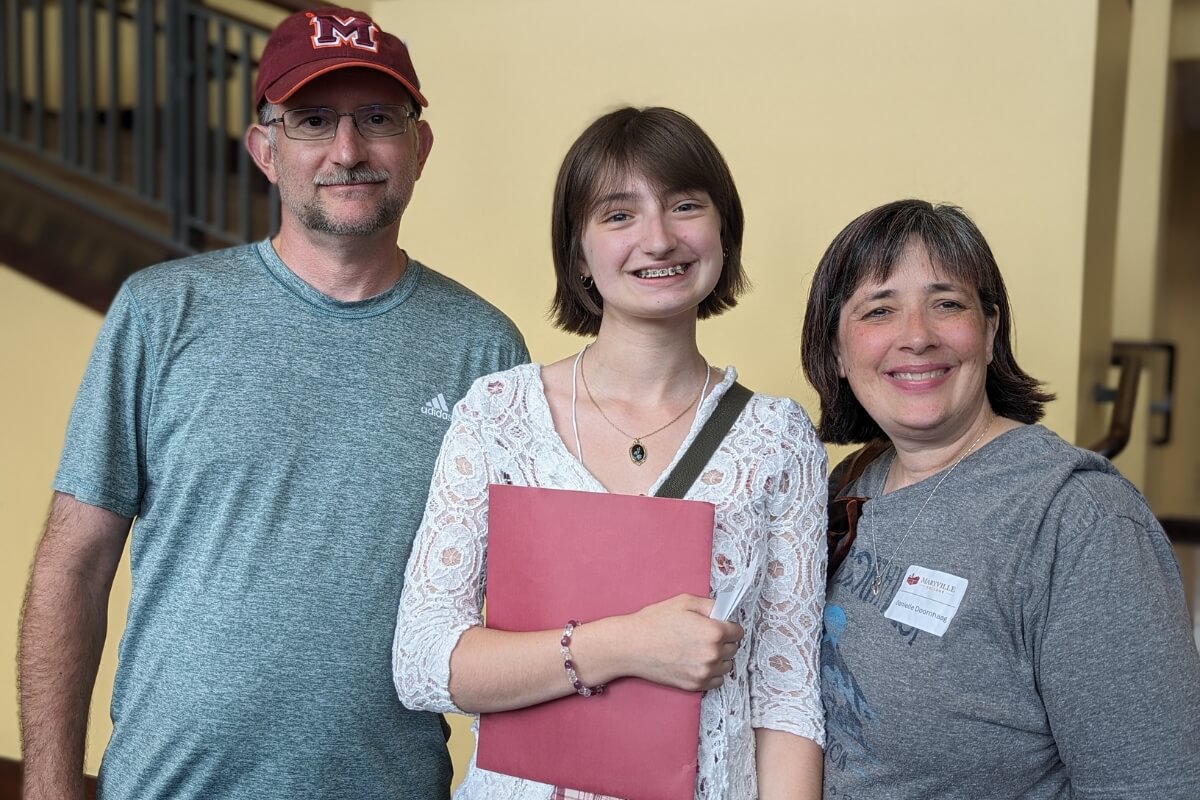 Photo of a smiling potential Scot and her parents