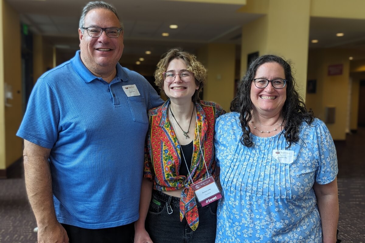 Photo of a smiling girl and her parents