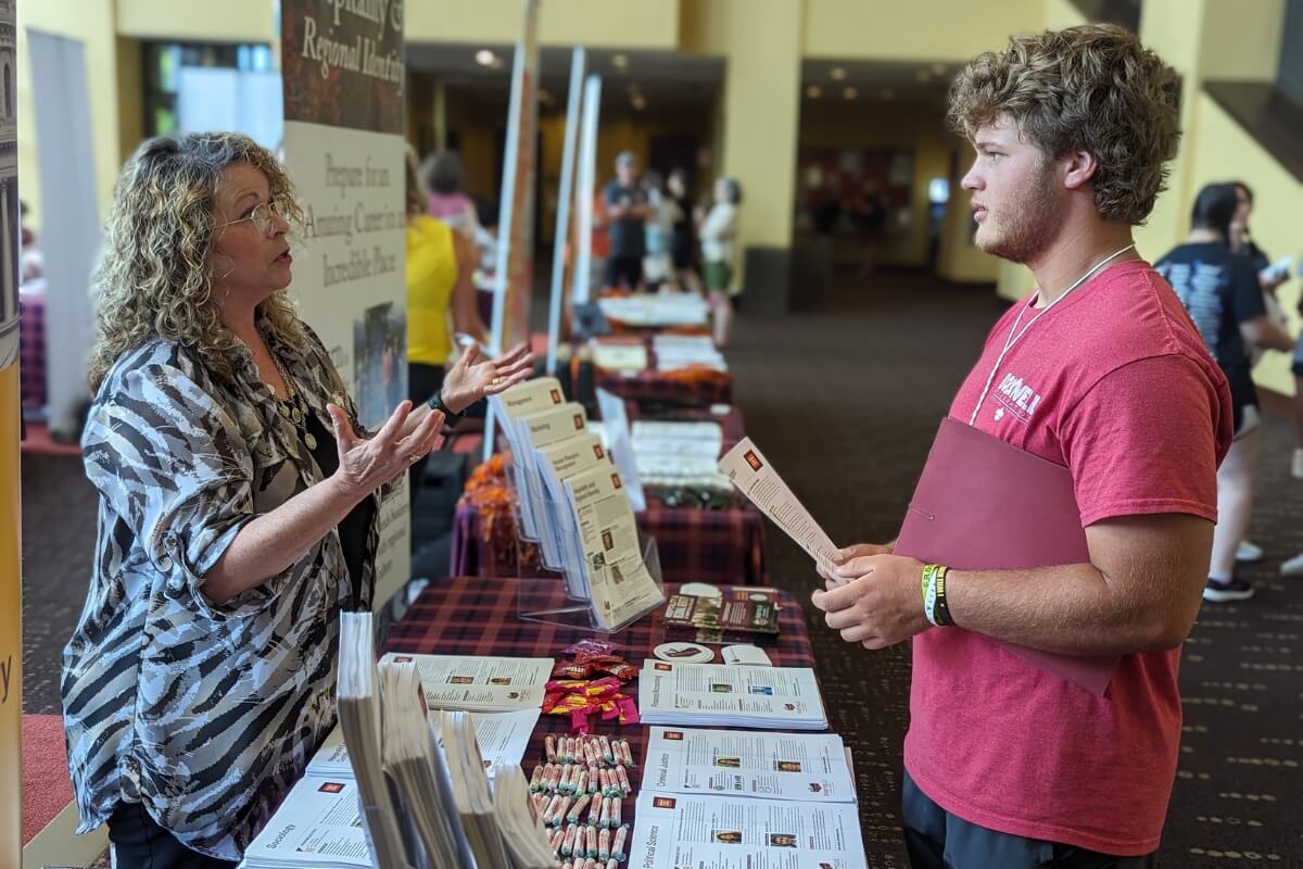 Photo of Dr. Angela Sebby talking with a student