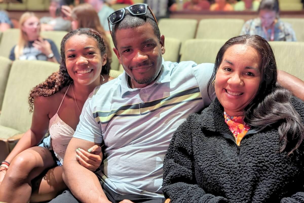 Photo of a smiling girl and her parents
