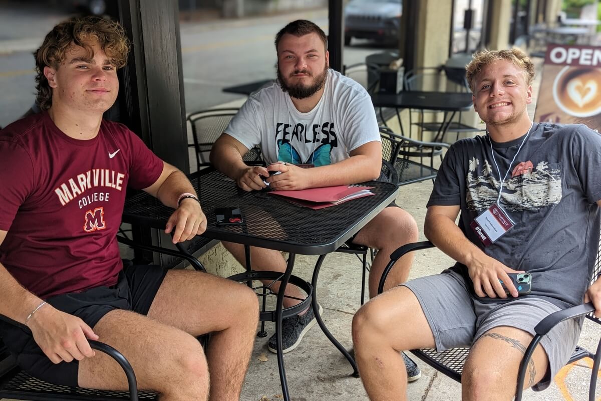 Photo of three potential Scots sitting on the patio at Vienna Coffeehouse