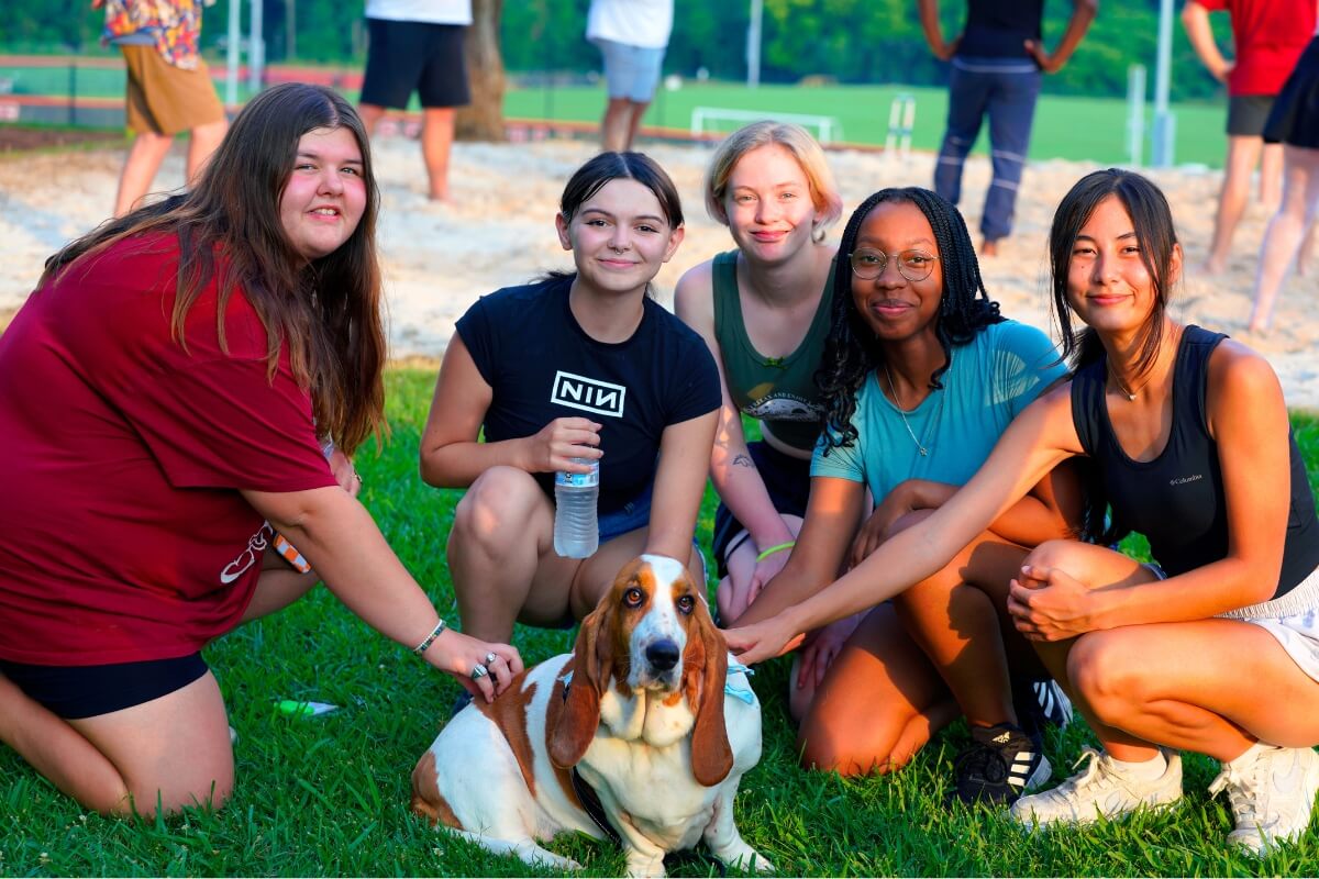 Photo of a group of potential students petting Dolly, the "first dog" of Maryville College