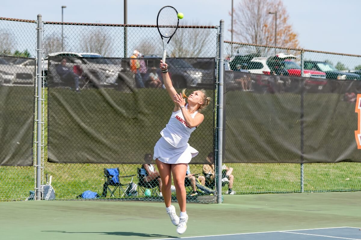 Photo of an MC tennis player taking a shot