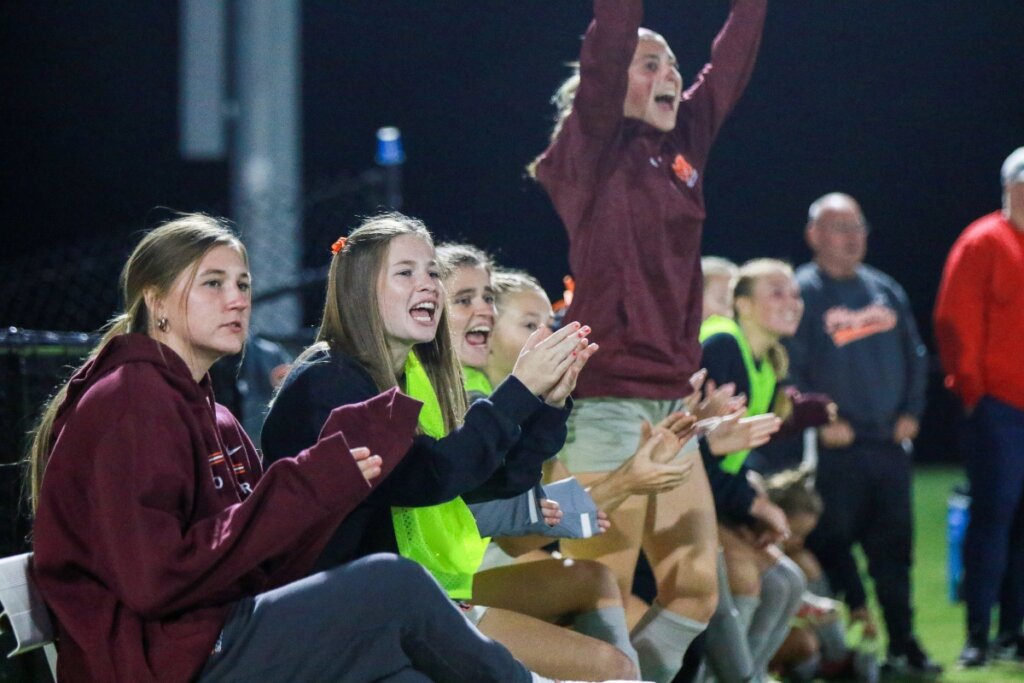 Photo of soccer players of the Maryville College women's athletics program cheering one another on.