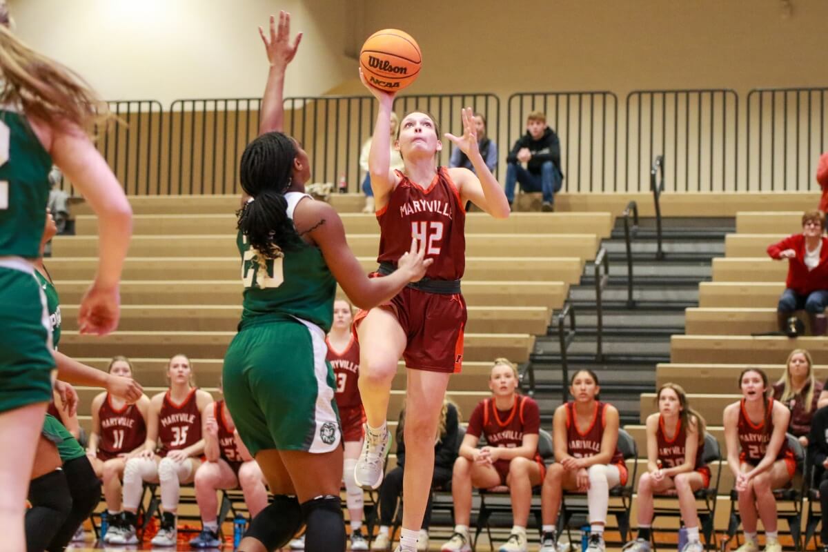 Photo of an MC basketball player taking a layup shot