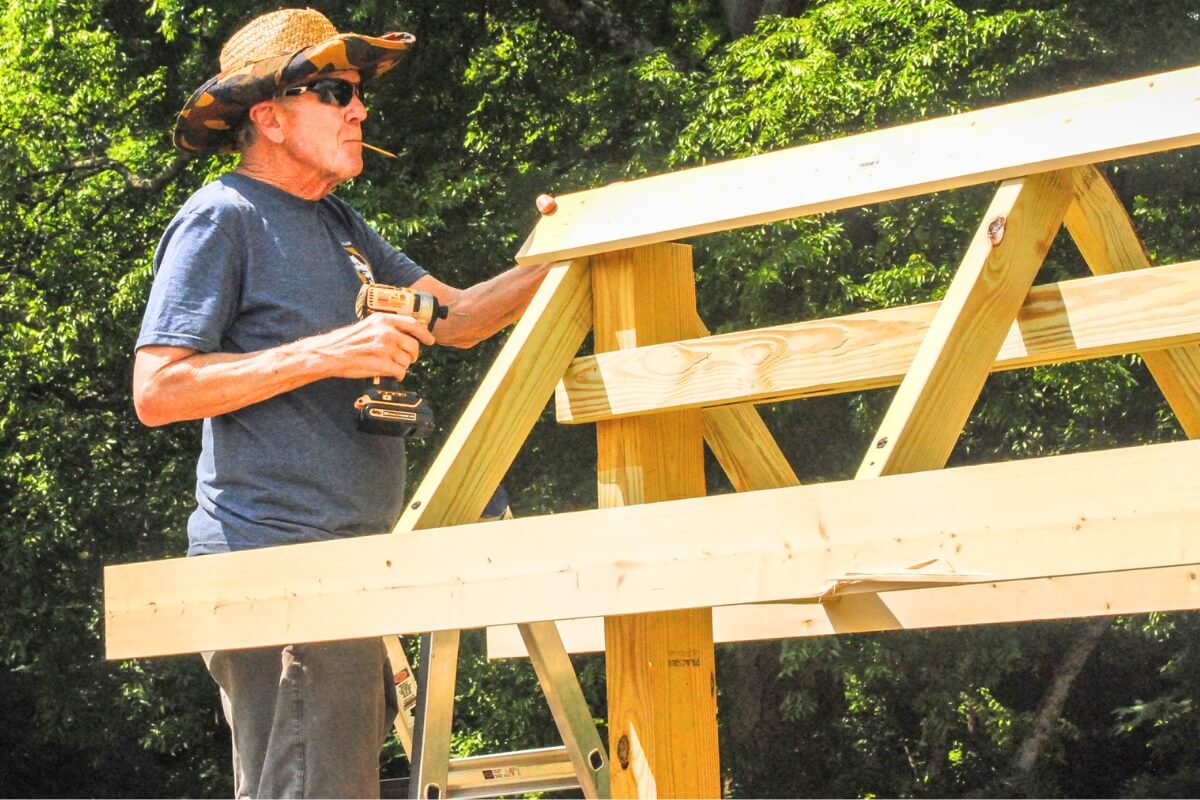 Photo of Dr. Marvin Beard '67 working on the MC Woods kiosk