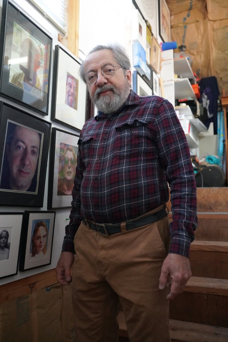 Photo of Carl Gombert standing on a staircase