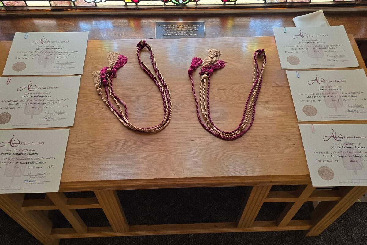 Photo of cords and certificates for inductees of one of Maryville College's honor societies.