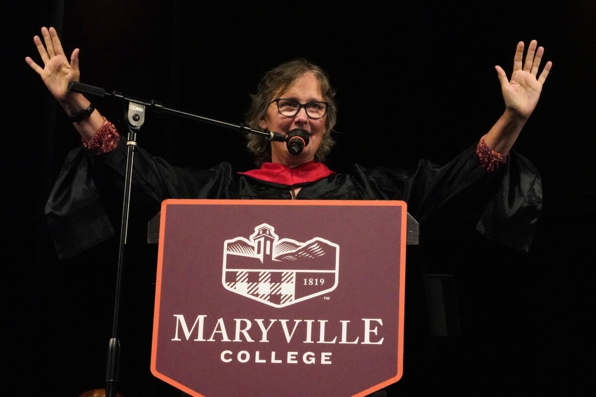 Photo of Interim Campus Minister Jamie Webster at the podium