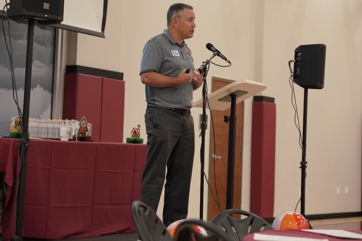 Photo of John Berry at a microphone