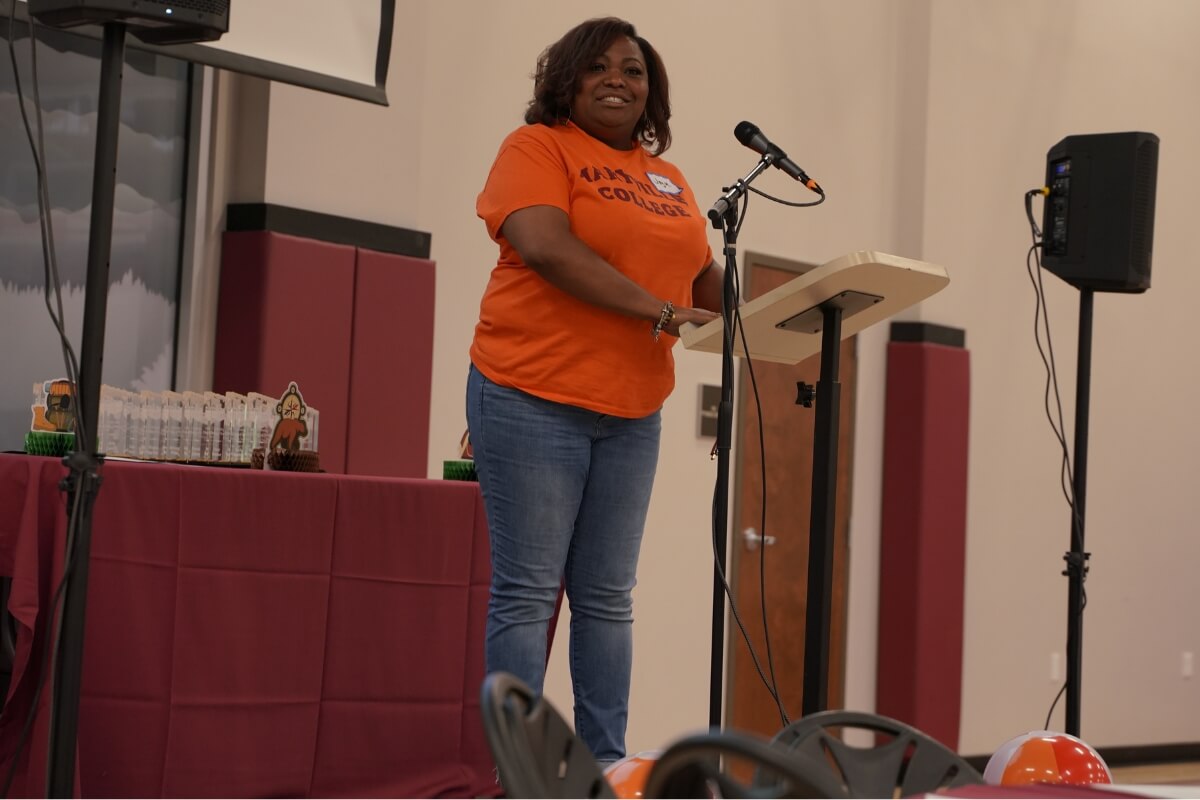 Photo of Joy McCamey talking into a microphone