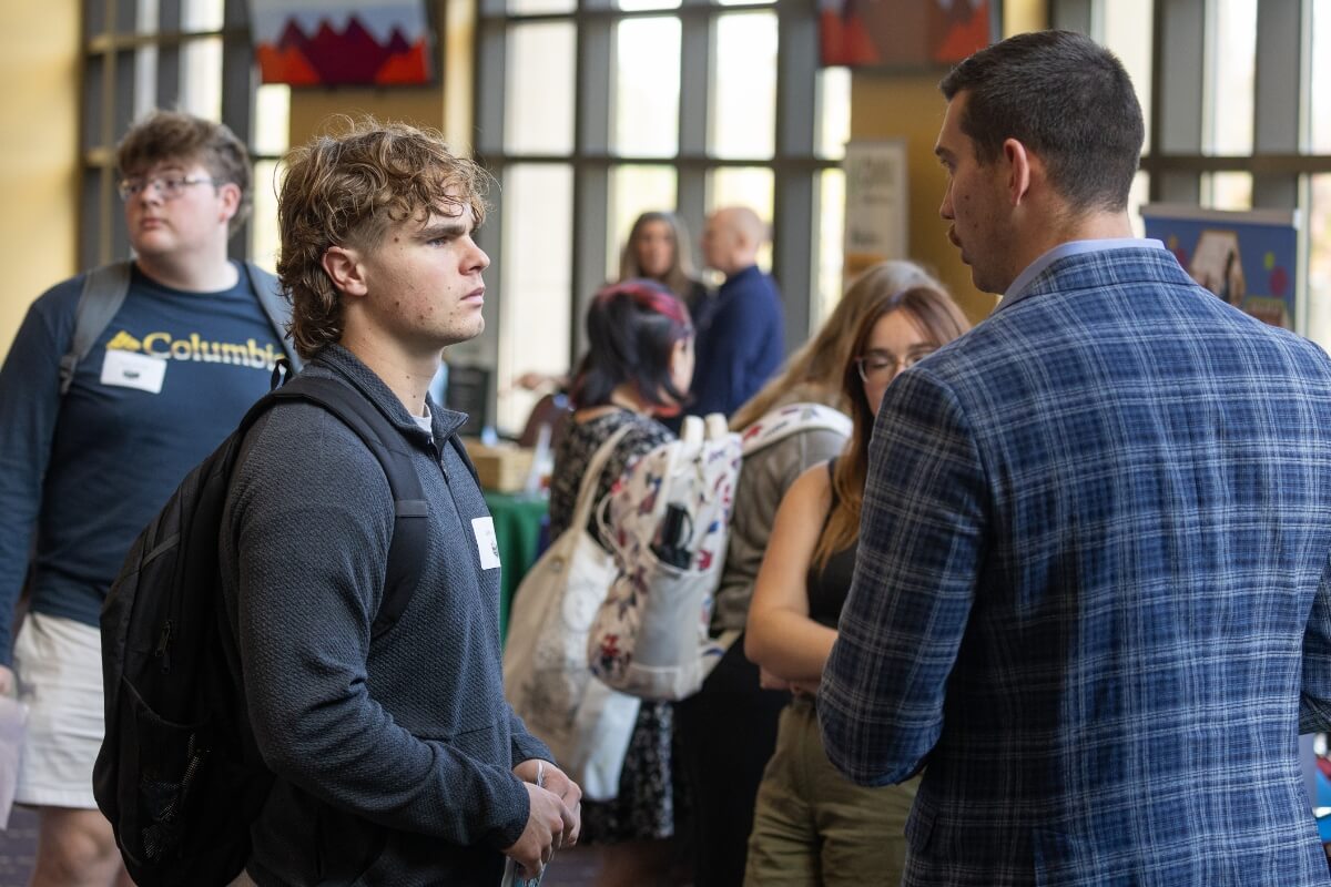 Photo of a student talking to an adult at the Maryville College Career Fair