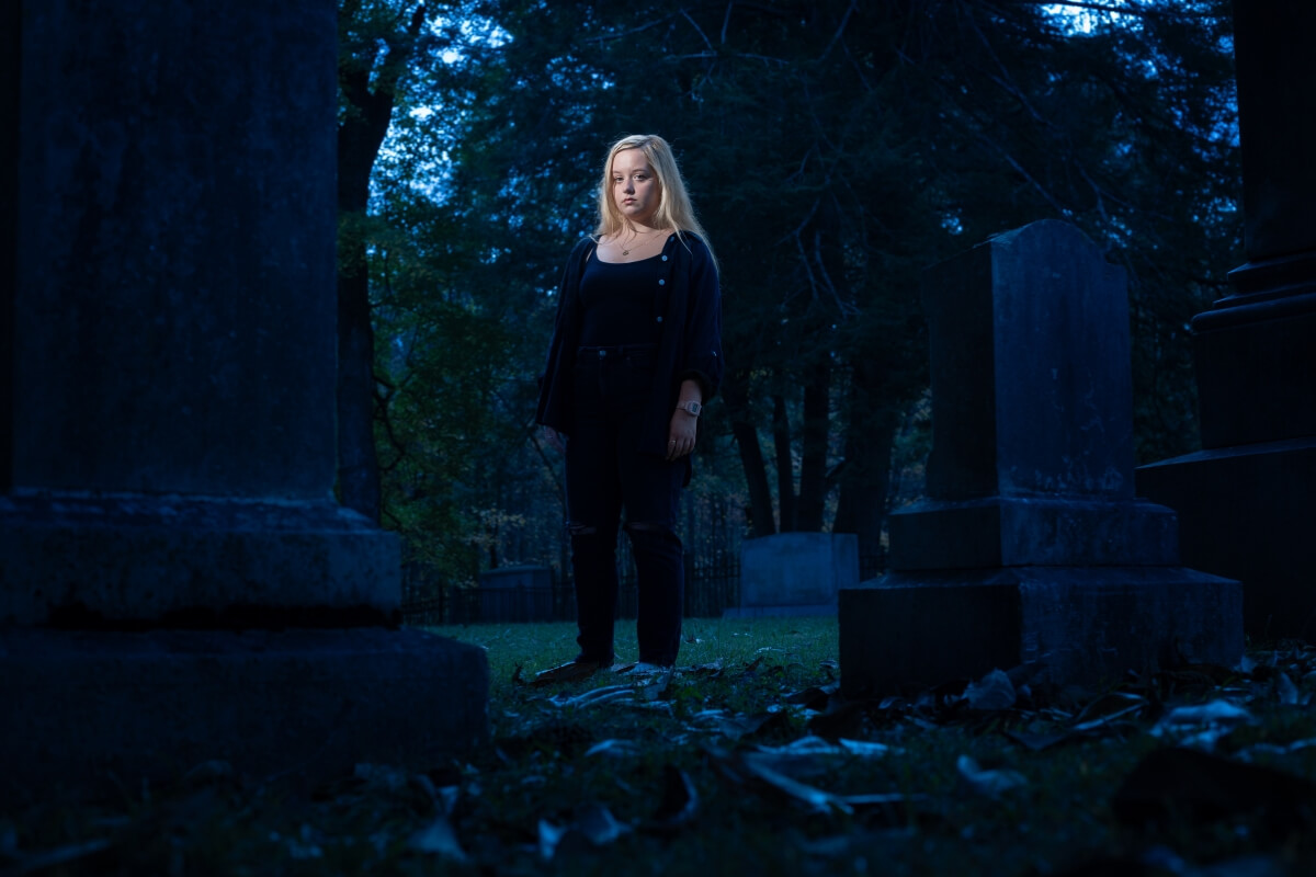 Photo of Grace Rubel, a Maryville College Humanities student, standing in the MC cemetery
