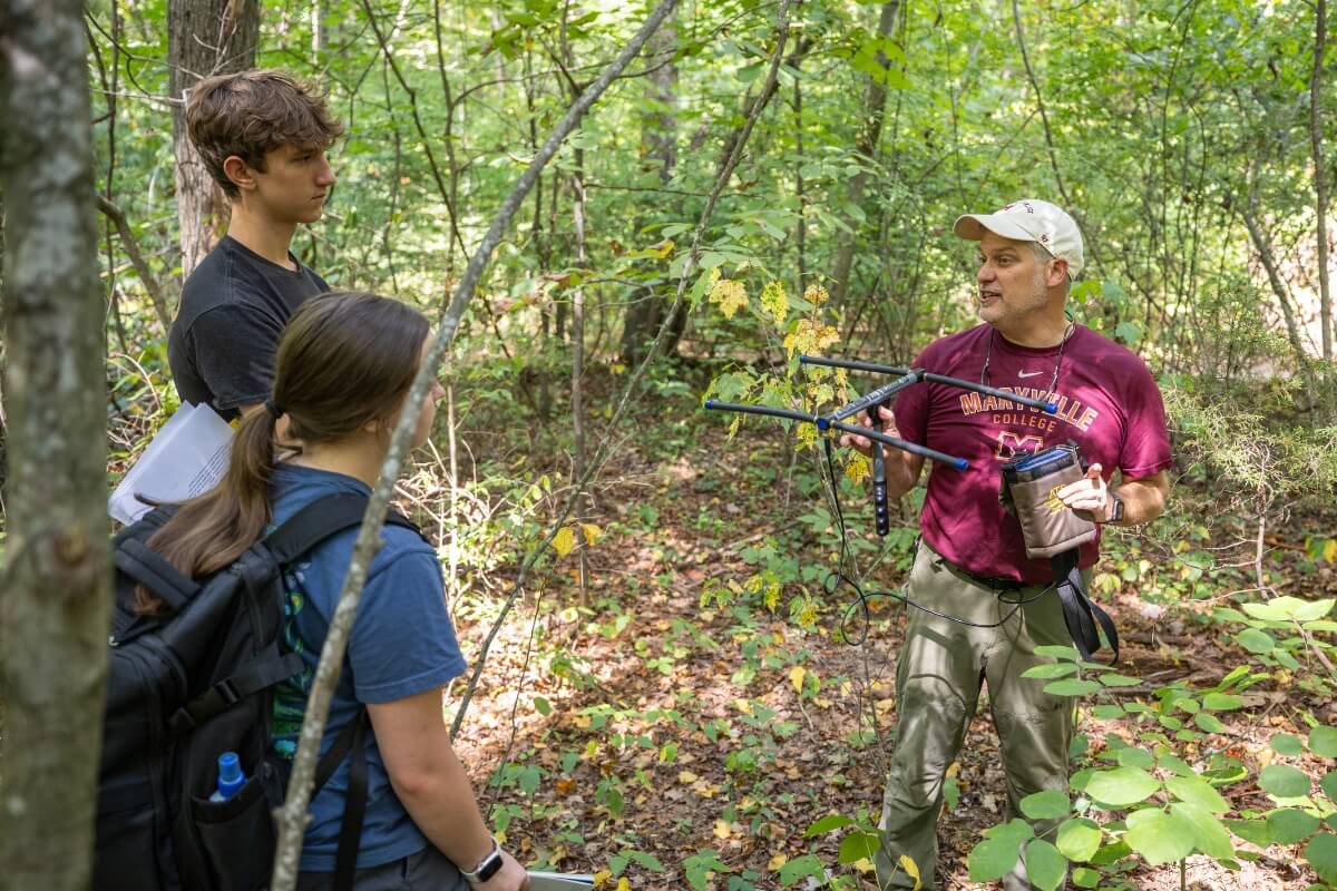 Phot of Dr. Dave Unger talking to students in the Maryville College Woods
