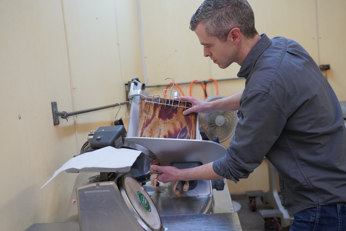Photo of Darrell Benton slicing ham