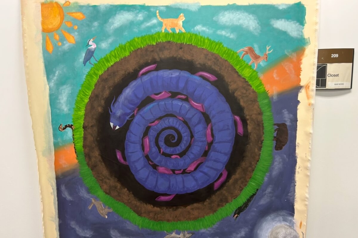 Photo of artwork hanging on the wall for a gallery display by Maryville College art students